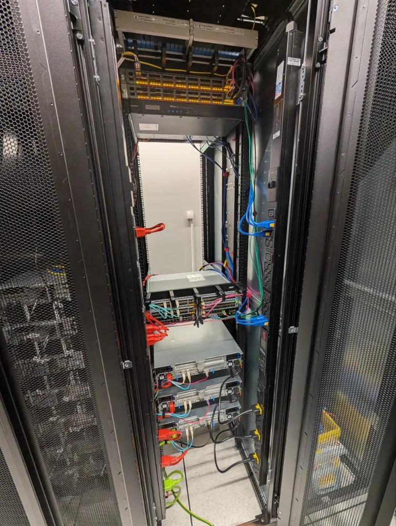 An open cabinet seen from above, showing dense network and power cabling.